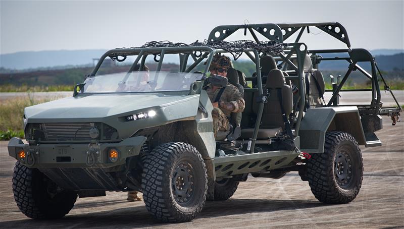 military vehicle with soldiers test driving
