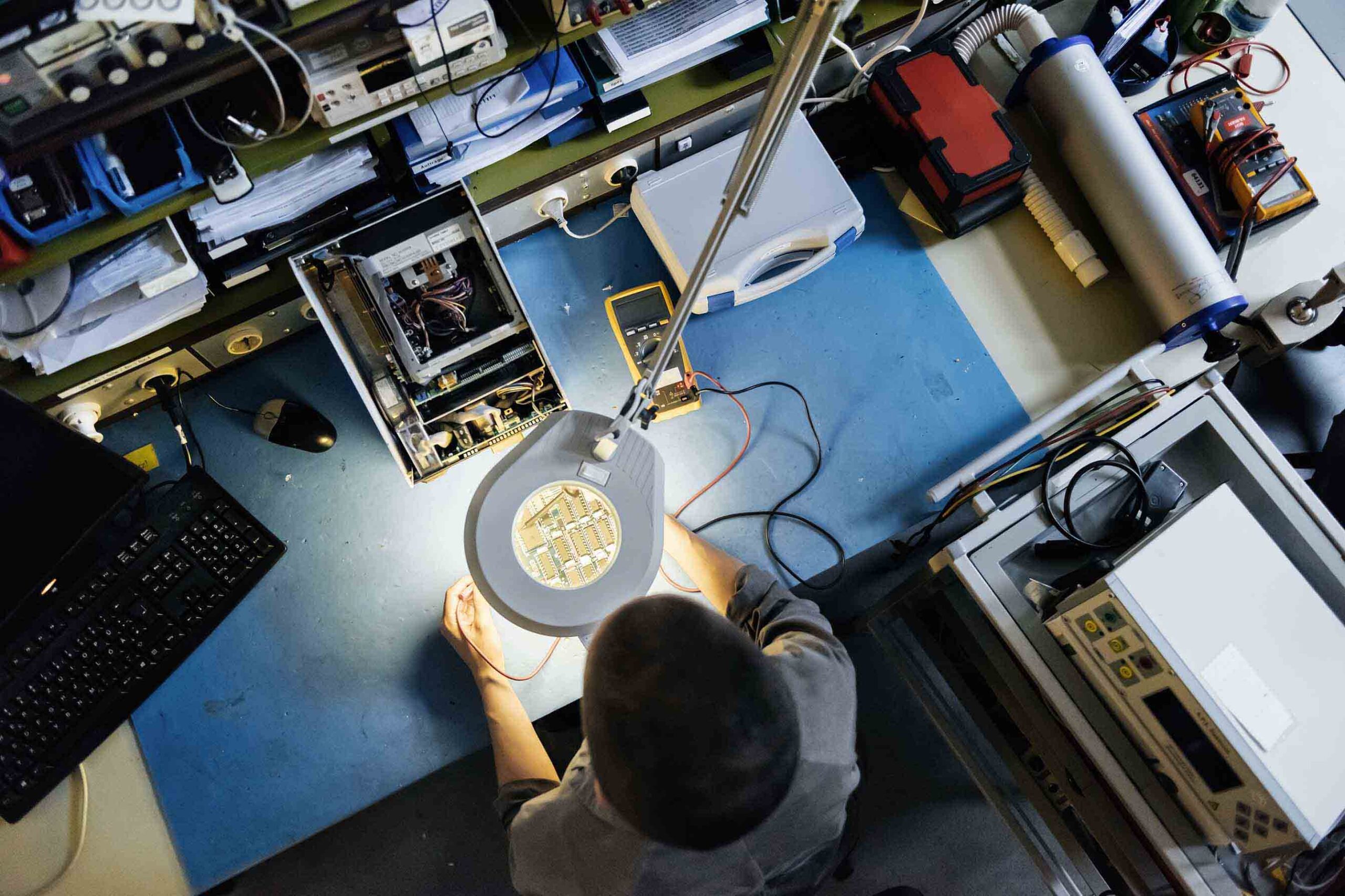 Aerial view of person working on electrical chip