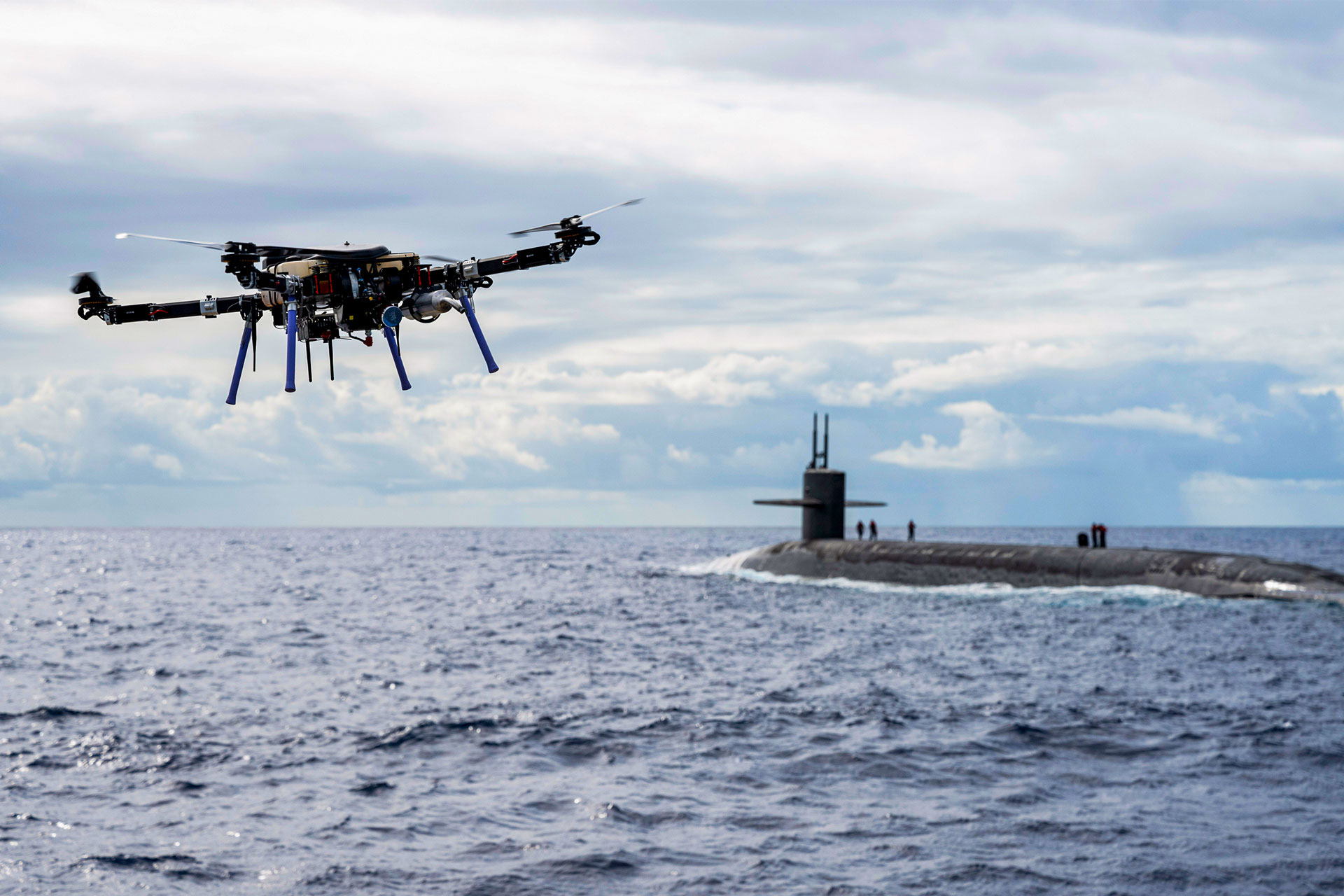 drone and submarine in ocean during the day