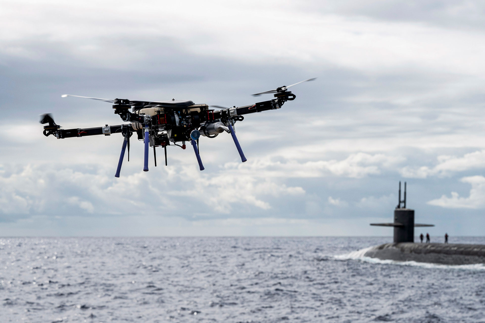 drone and submarine in ocean during the day