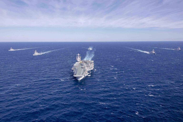 several naval ships approaching in ocean