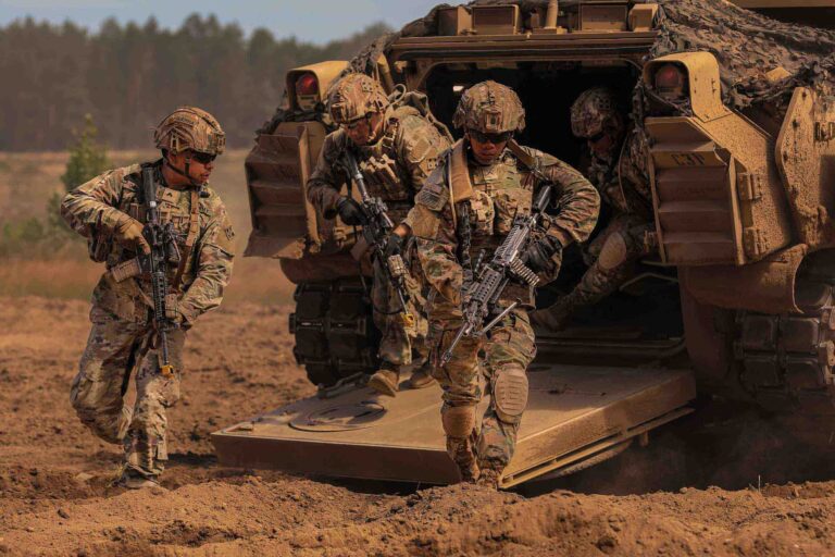 Soldiers exiting bradley fighting vehicle
